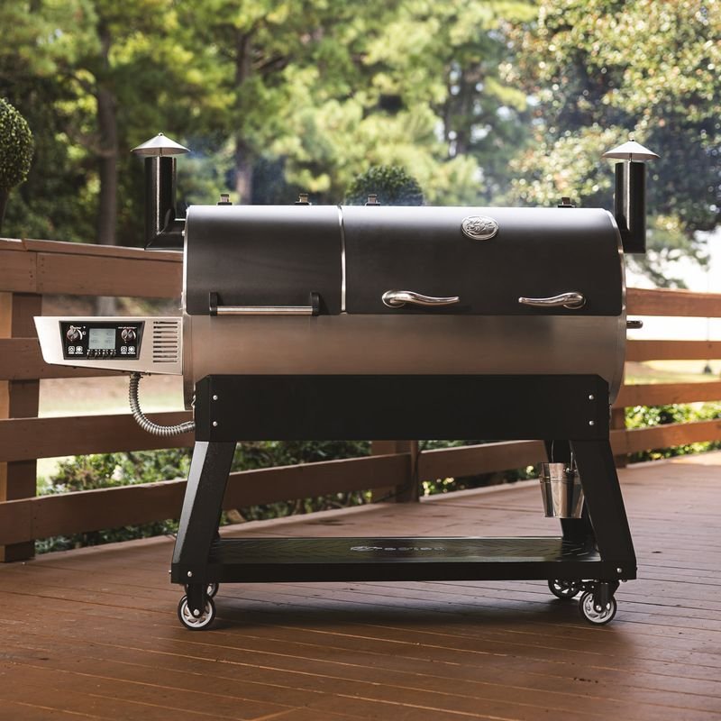 A pellet grill with a side hopper and digital controller on an outdoor deck